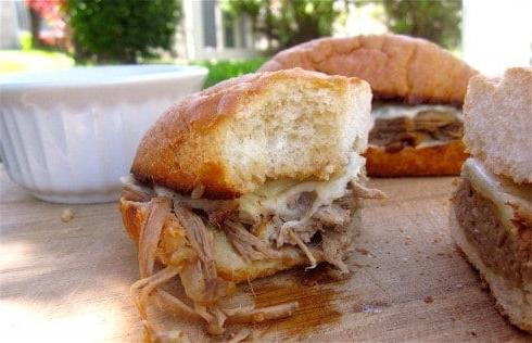 IMG_4168 Half of french dip sandwich with bite out of it and full sandwich in the background.