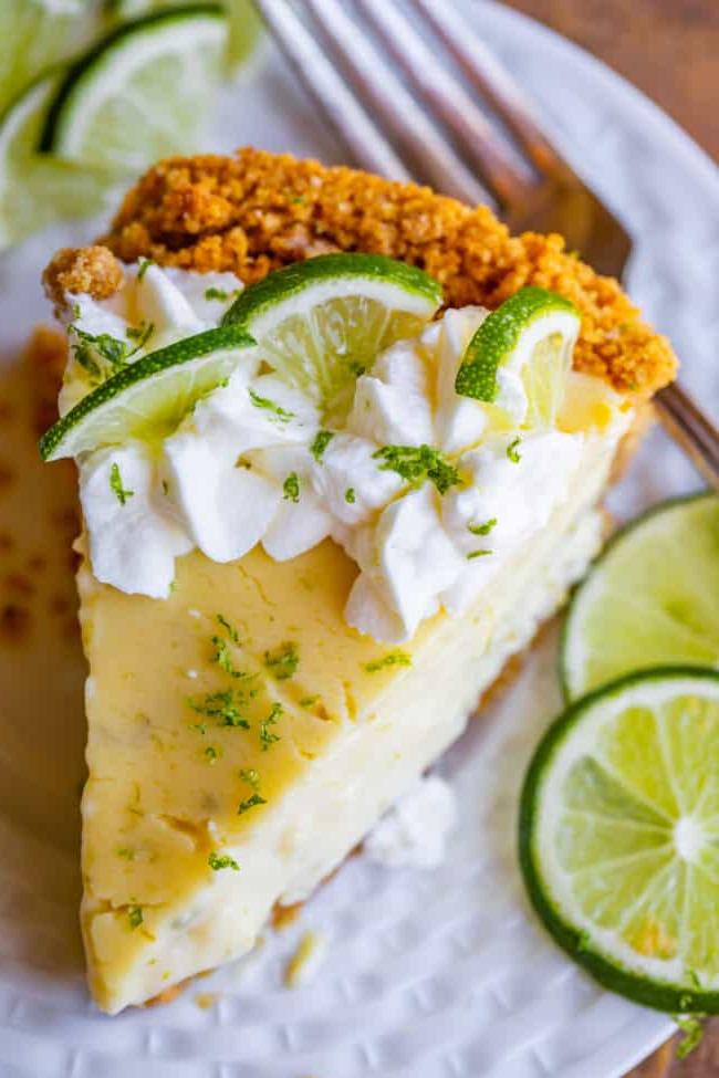 Μια φέτα Key lime pie με βάση μπισκότου graham, σαντιγί και φέτες λάιμ.