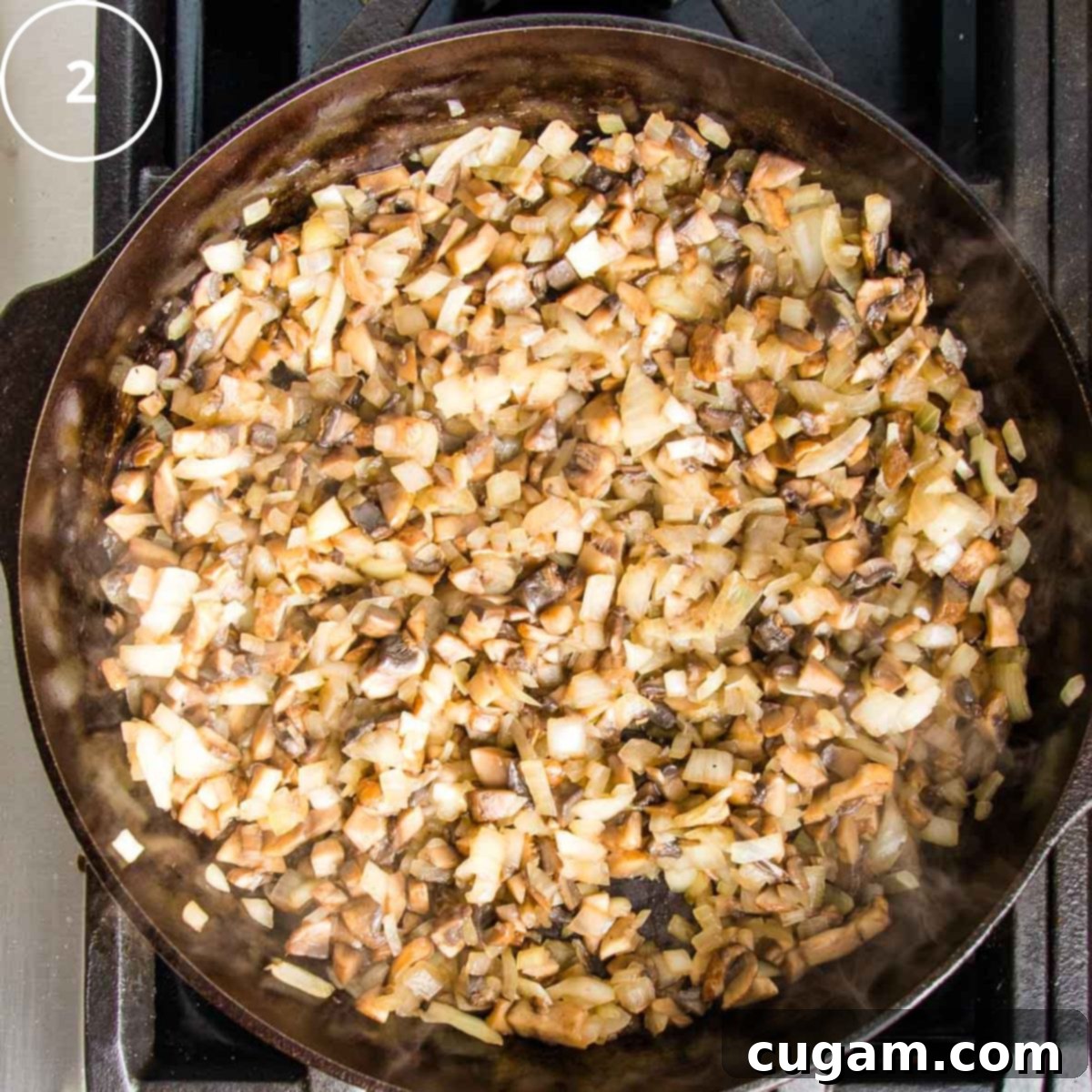 Sauteed onions and mushrooms in a cast iron skillet.