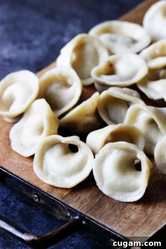 Mushroom Pierogi Uszka on a wooden board, ready to be served or cooked.