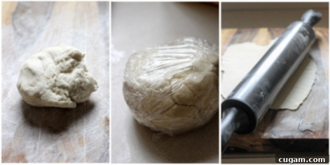 Process shot of pierogi dough resting, covered with plastic wrap.