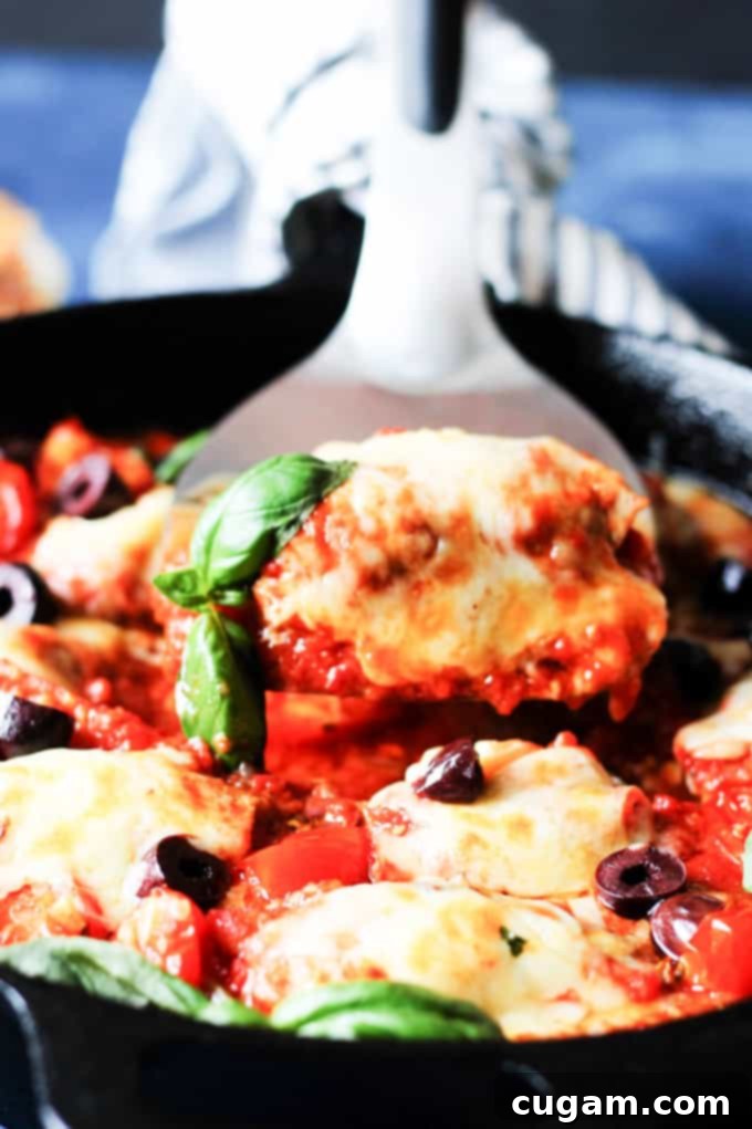 Veal rollatini in tomato sauce picked up from the skillet with spatula