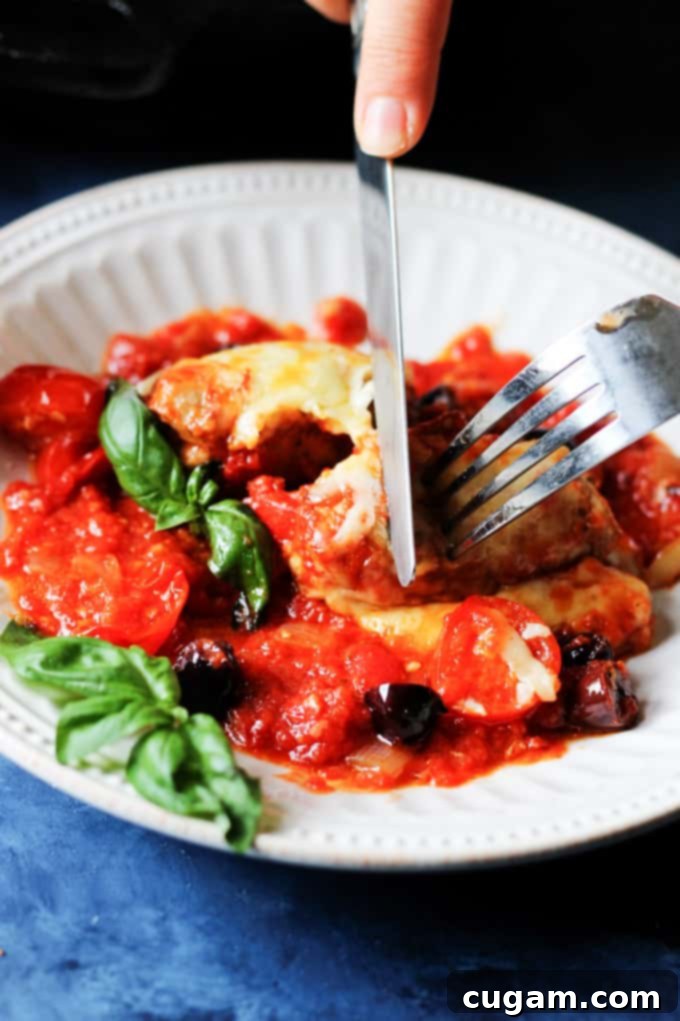 Veal Rollatini on a plate with fork and knife