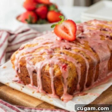 Baked strawberry banana bread with strawberry on top.