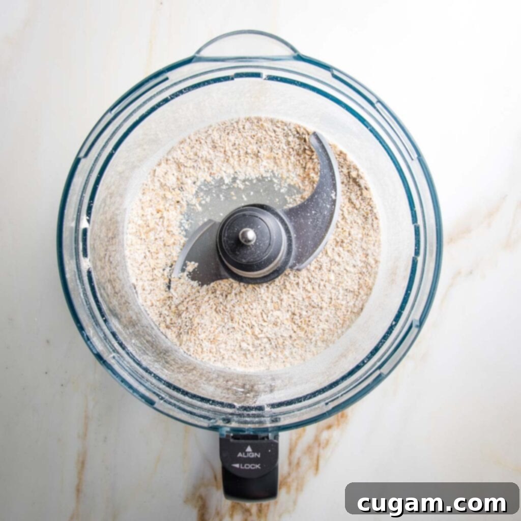 Ground oats in a food processor bowl.