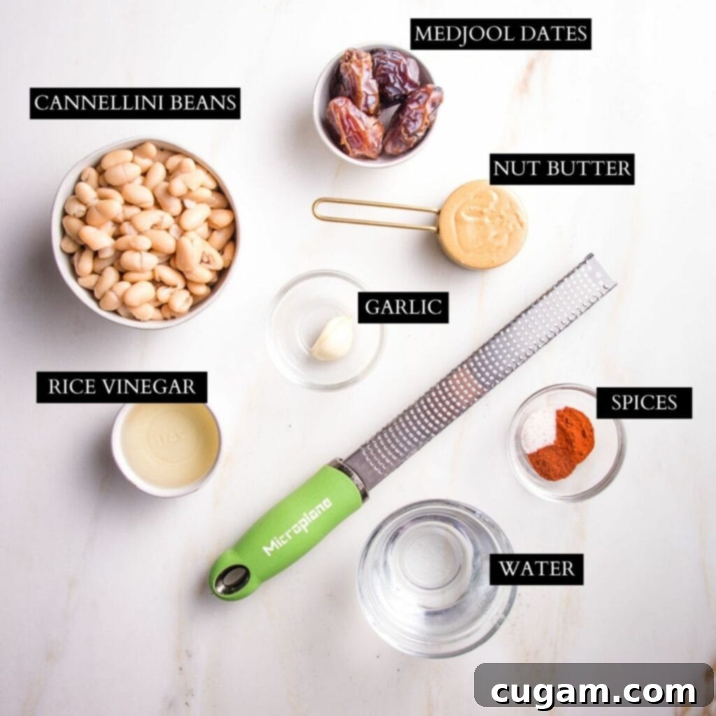 Ingredients for chipotle dressing including cannellini beans, dates, garlic, nut butter, chipotle powder, and rice vinegar.