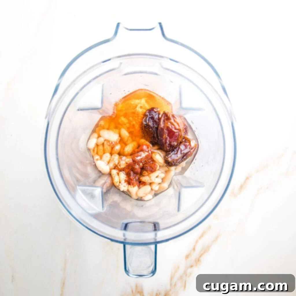 Blender blending ingredients into a smooth, creamy sauce.