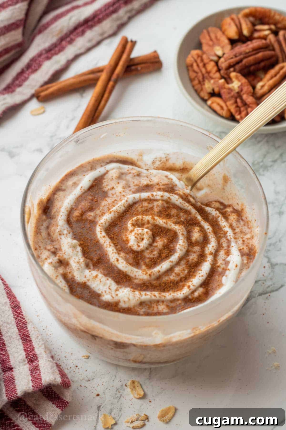 Swirl of greek yogurt on cinnamon roll overnight oats.