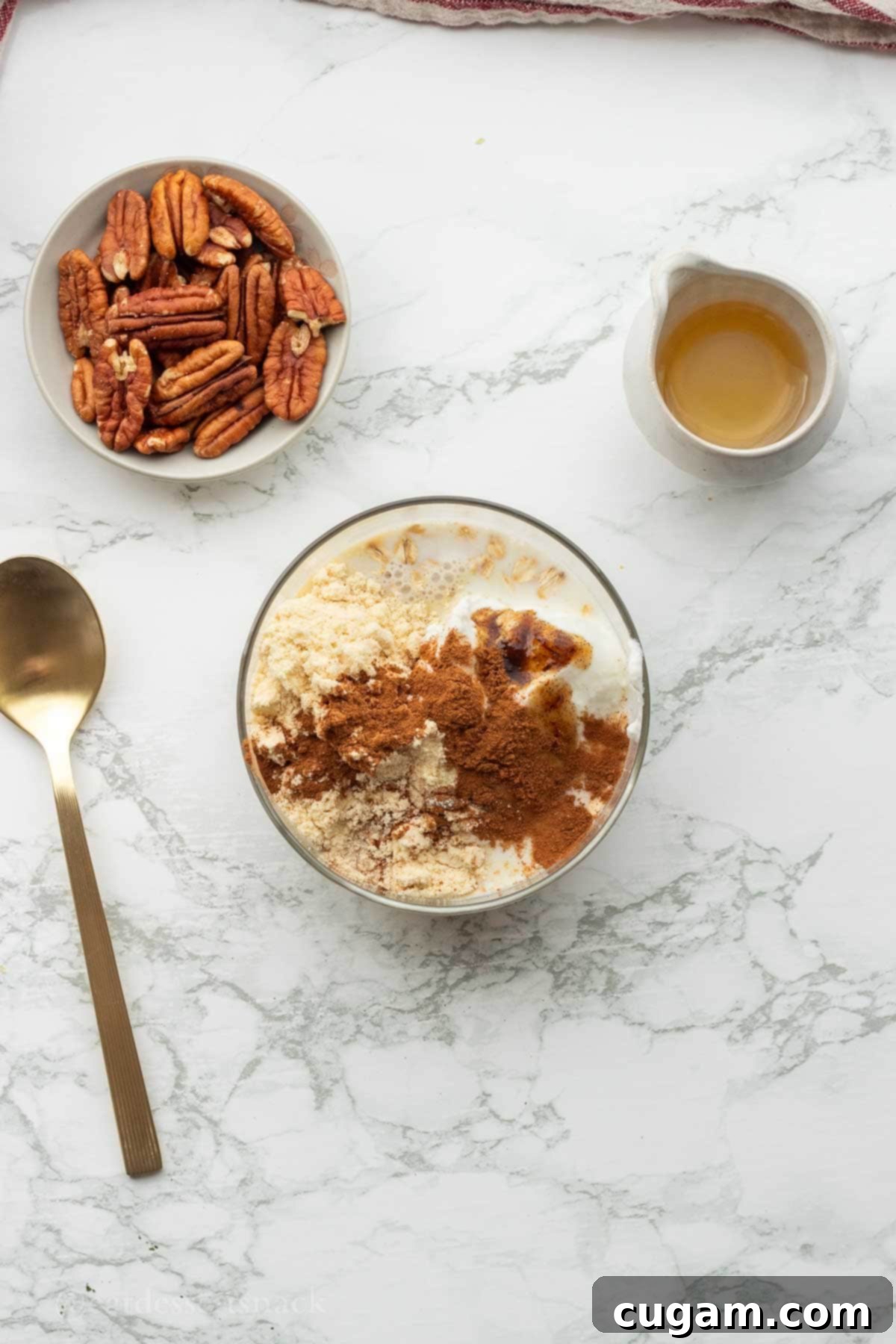 Cinnamon, protein powder, milk in bowl of oats.