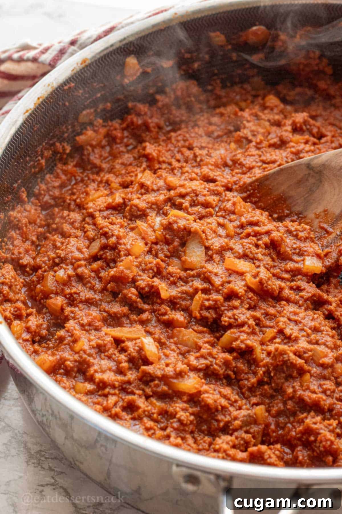 Cooked ground turkey sloppy joe sauce in metal pan.