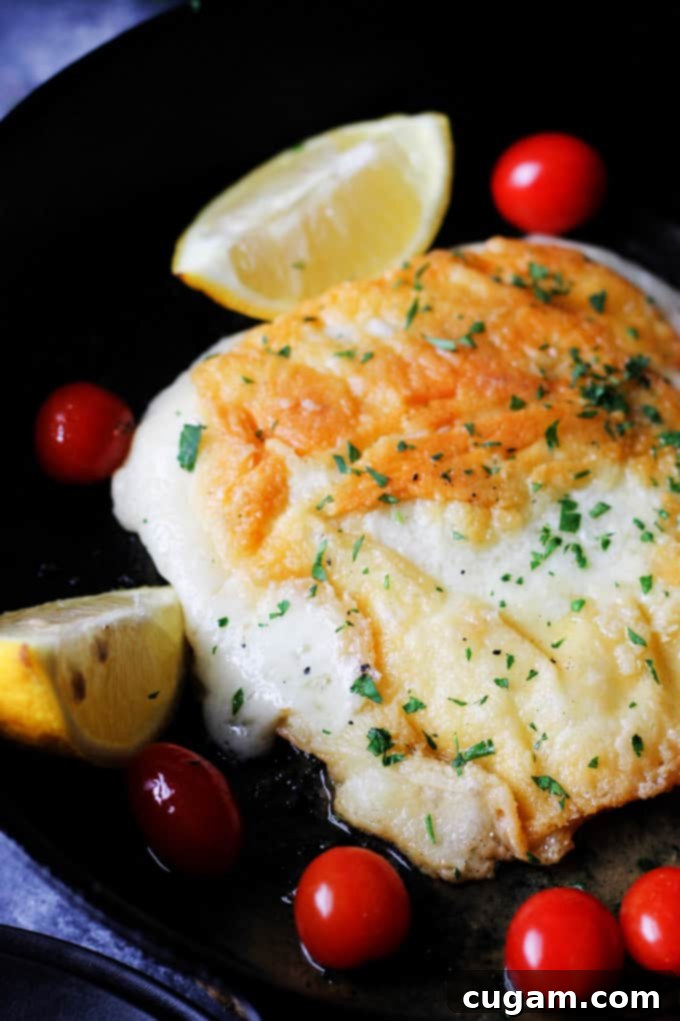 Greek Saganaki served on a plate with fresh lemon and cherry tomatoes