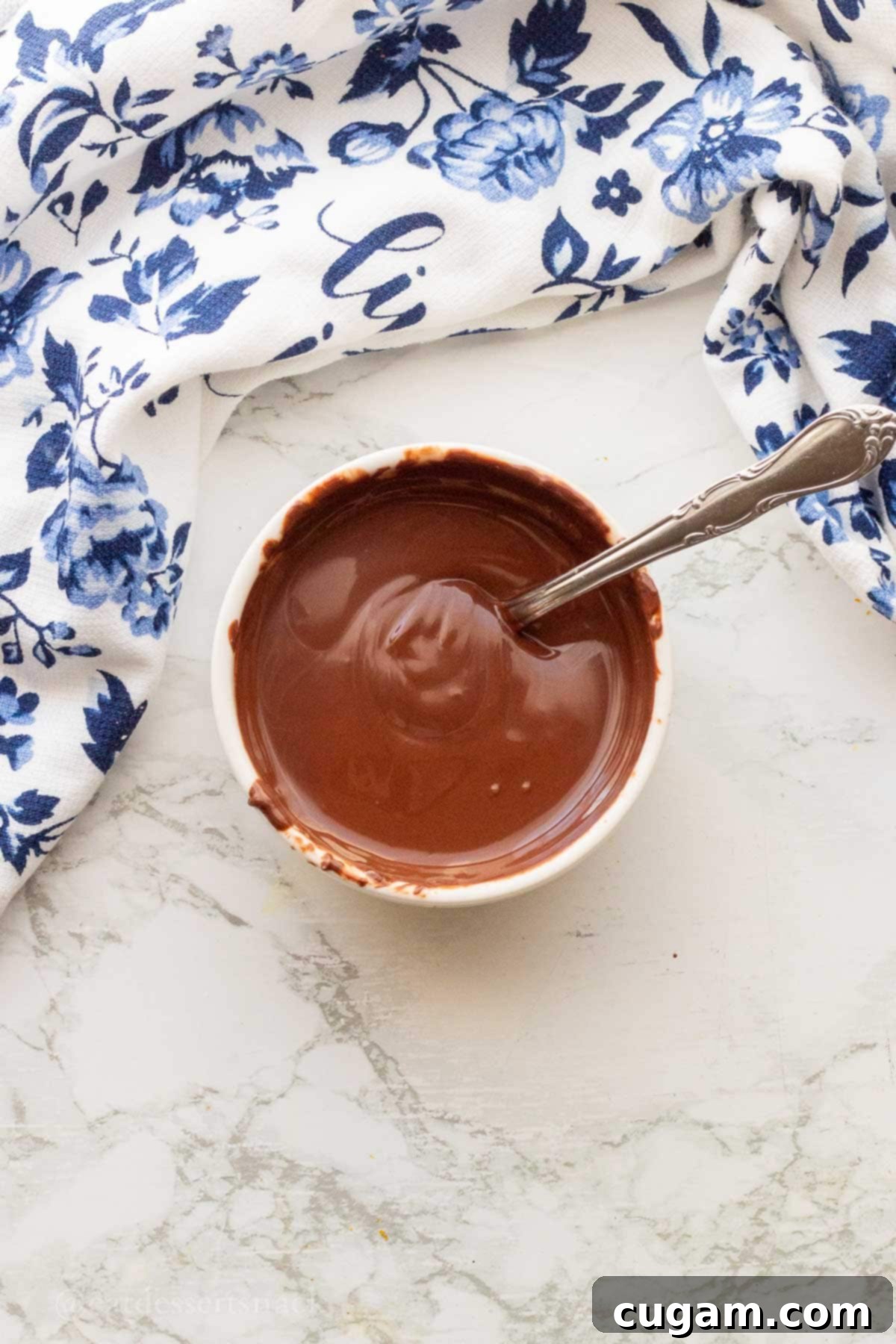 Melted chocolate in white bowl.