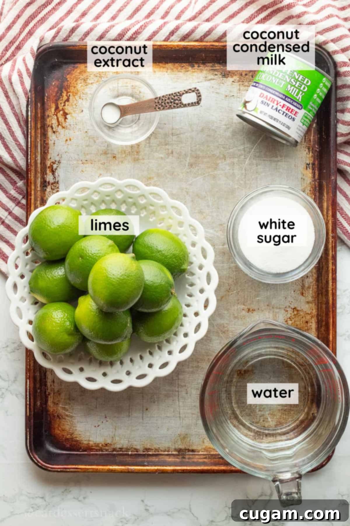 Labeled ingredients for coconut limeade on metal tray.