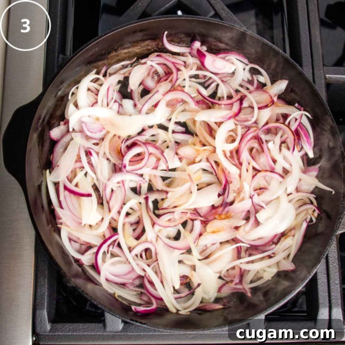 Thinly sliced purple onions beginning to soften and sizzle in a heavy cast iron skillet, signaling the start of the caramelization process.