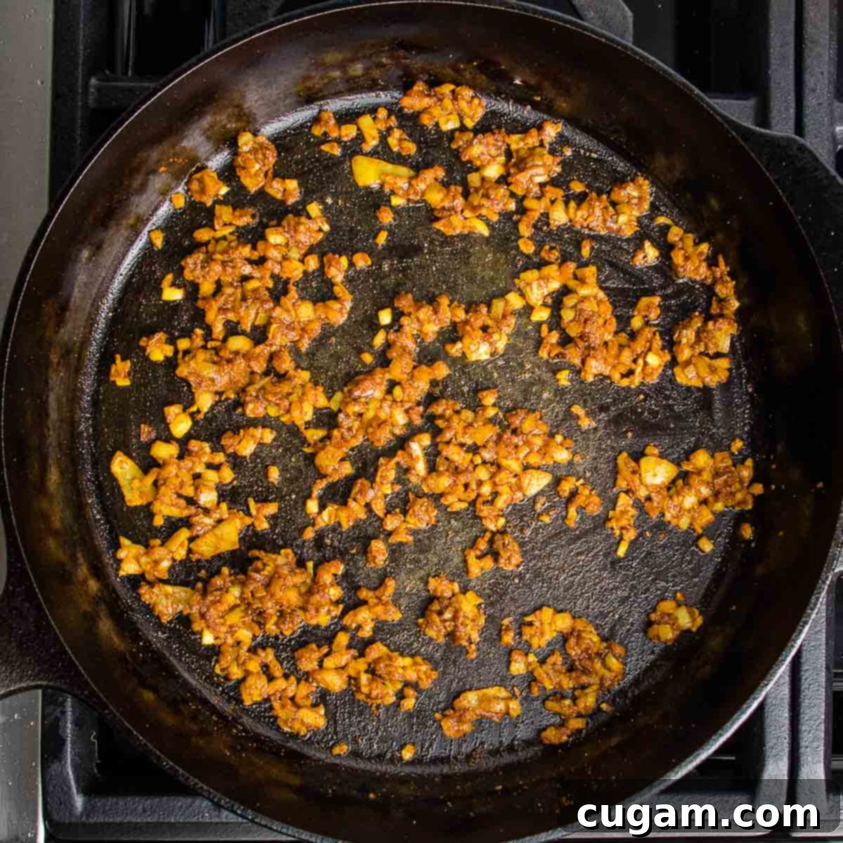 Onions, garlic and spices sauteed in a cast iron skillet