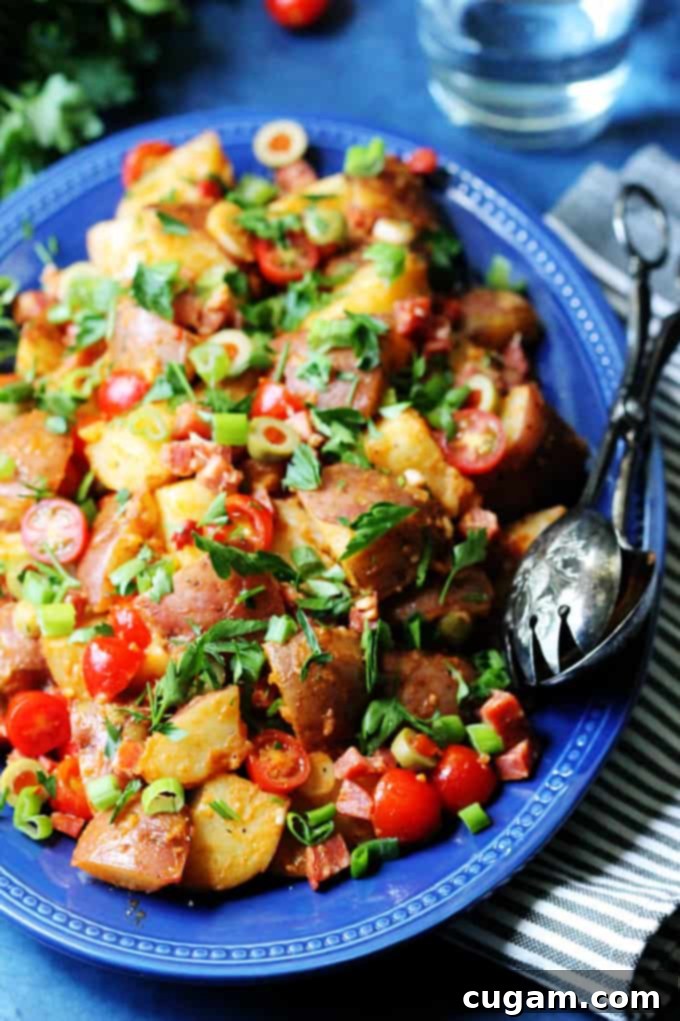 Smoky Spanish Potato Salad with Roasted Peppers and Chorizo on a serving plate