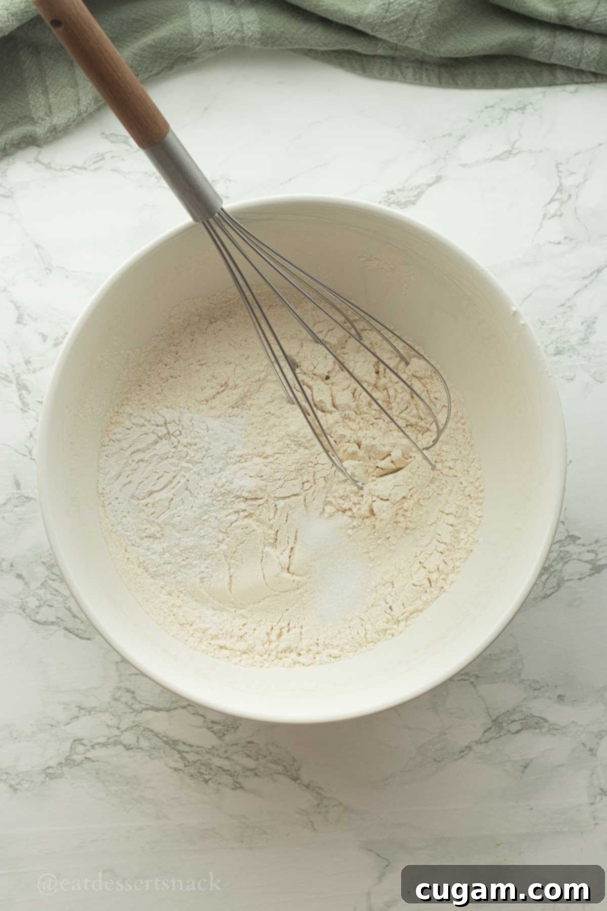 Flaky Sourdough Discard Biscuits 4 Dry ingredients with whisk in bowl.
