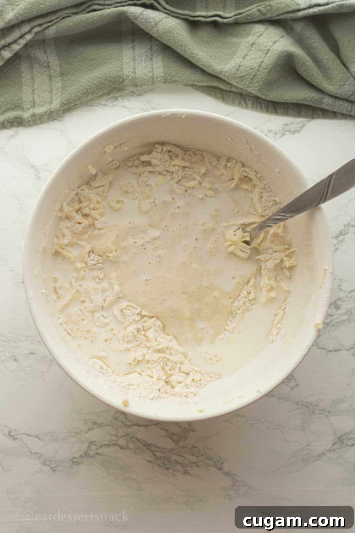 Flaky Sourdough Discard Biscuits 6 Sourdough discard and milk in biscuit dough bowl.
