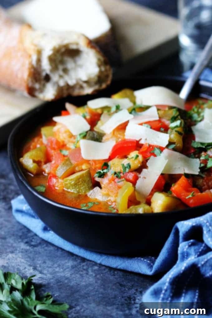 Spanish Ratatouille in a black bowl with spoon 