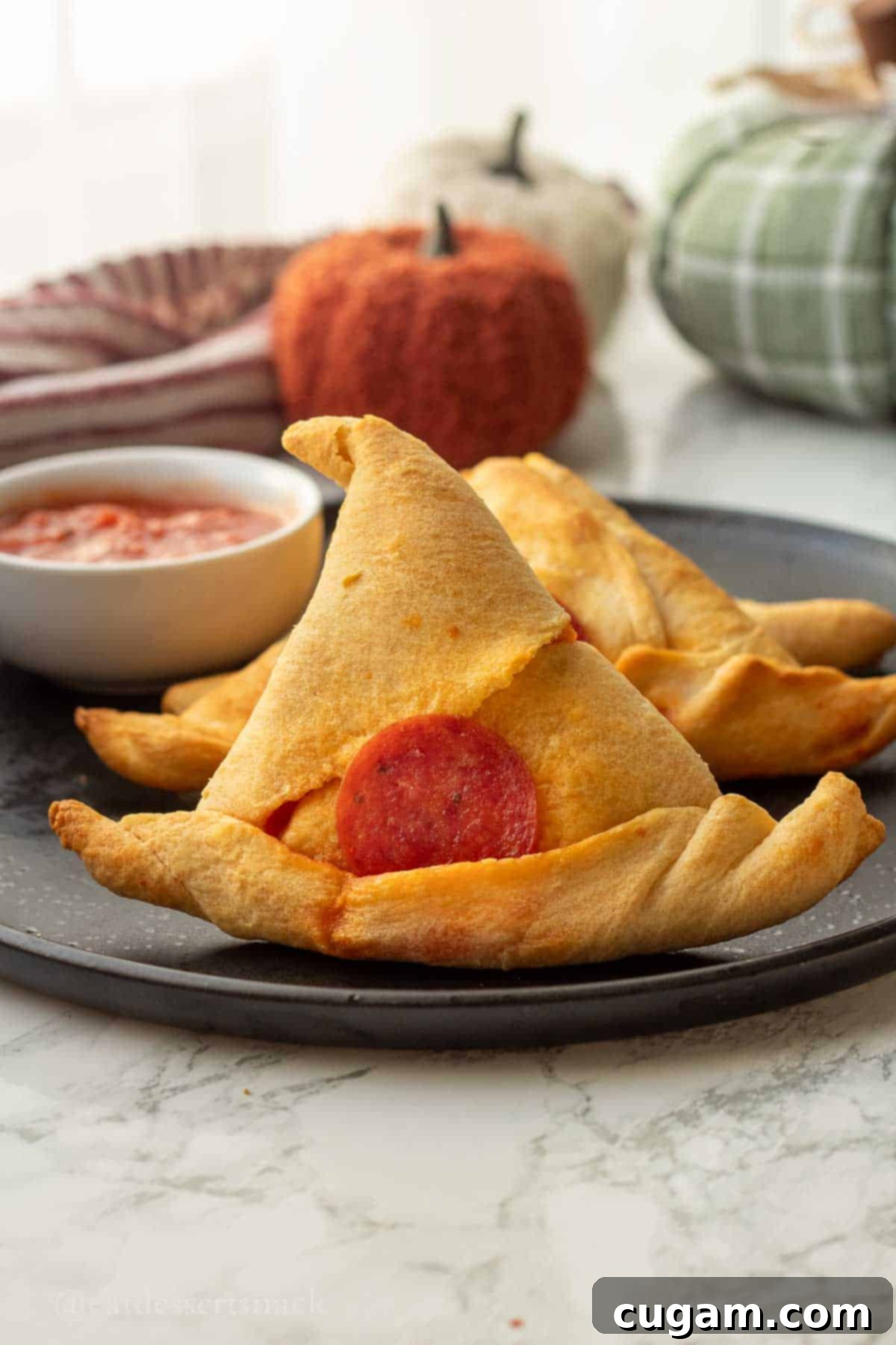 Halloween Witchy Crescent Treats 2 Baked witch had crescent roll on black plate.