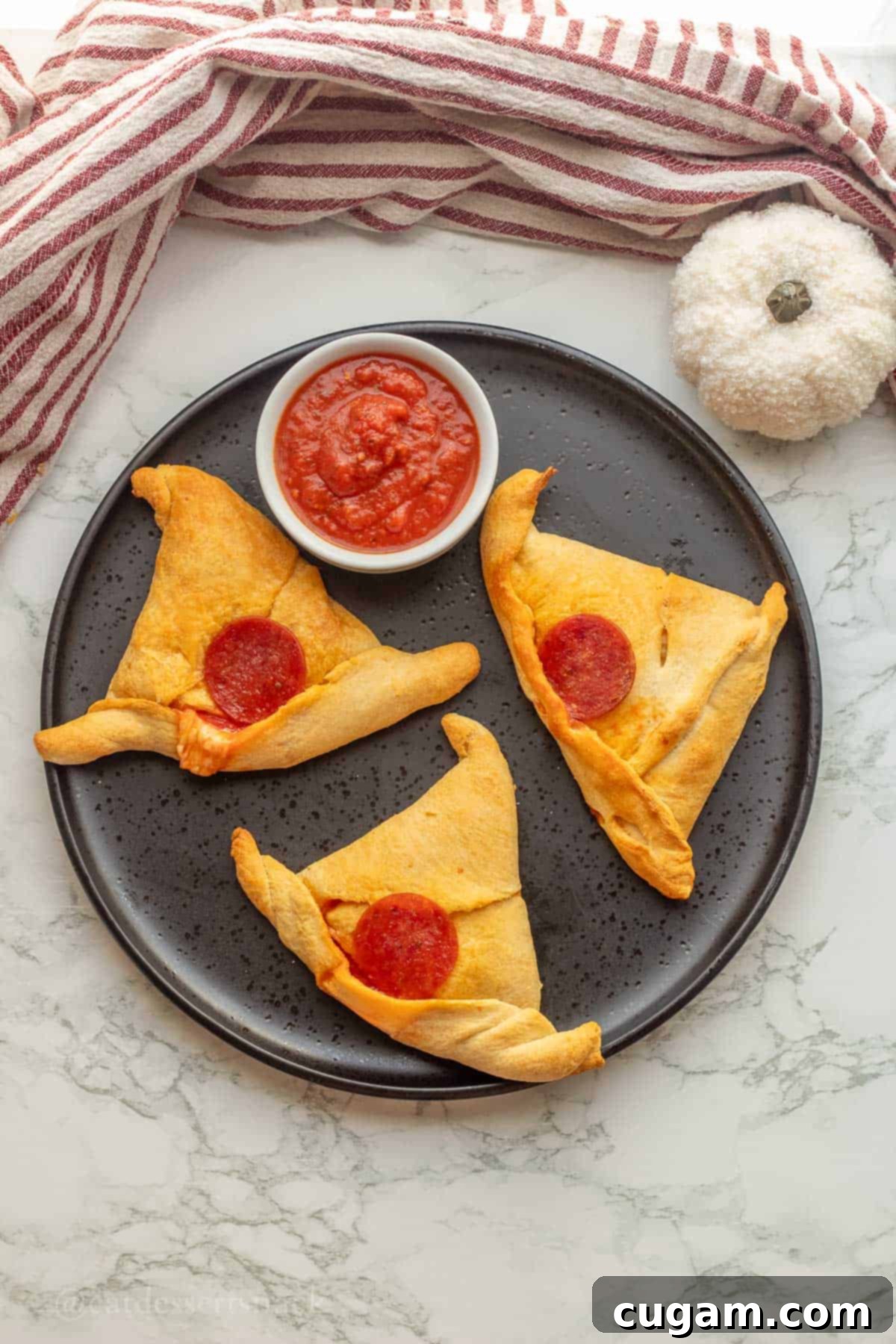 Halloween Witchy Crescent Treats 11 3 baked witch had rolls on plate with pizza sauce in a dish.