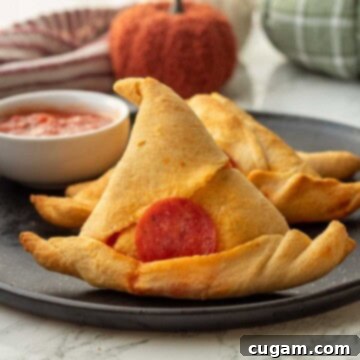 Halloween Witchy Crescent Treats 12 Baked witch had crescent roll on black plate.