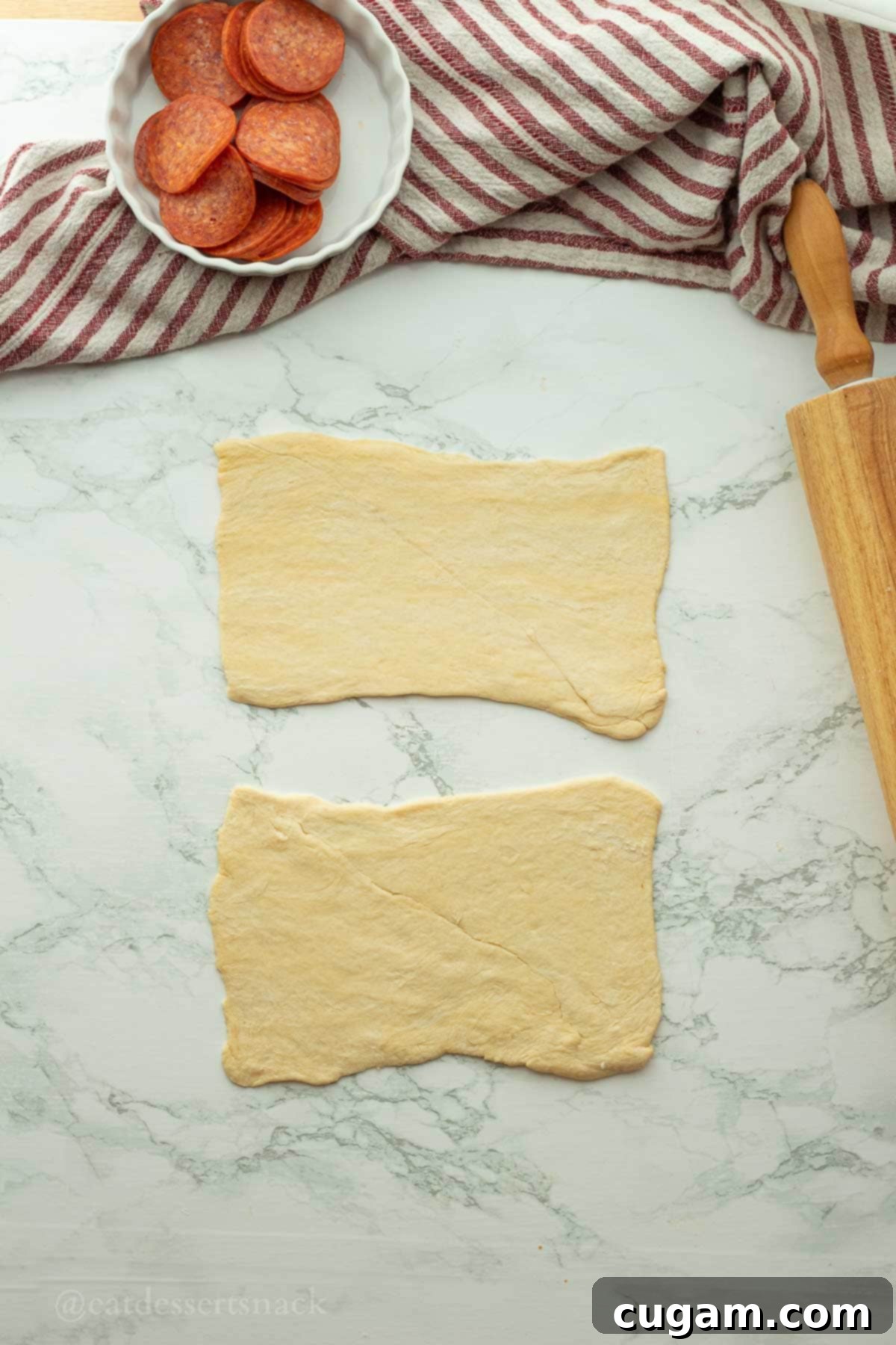 Halloween Witchy Crescent Treats 4 Flattened dough in rectangles with rolling pin.