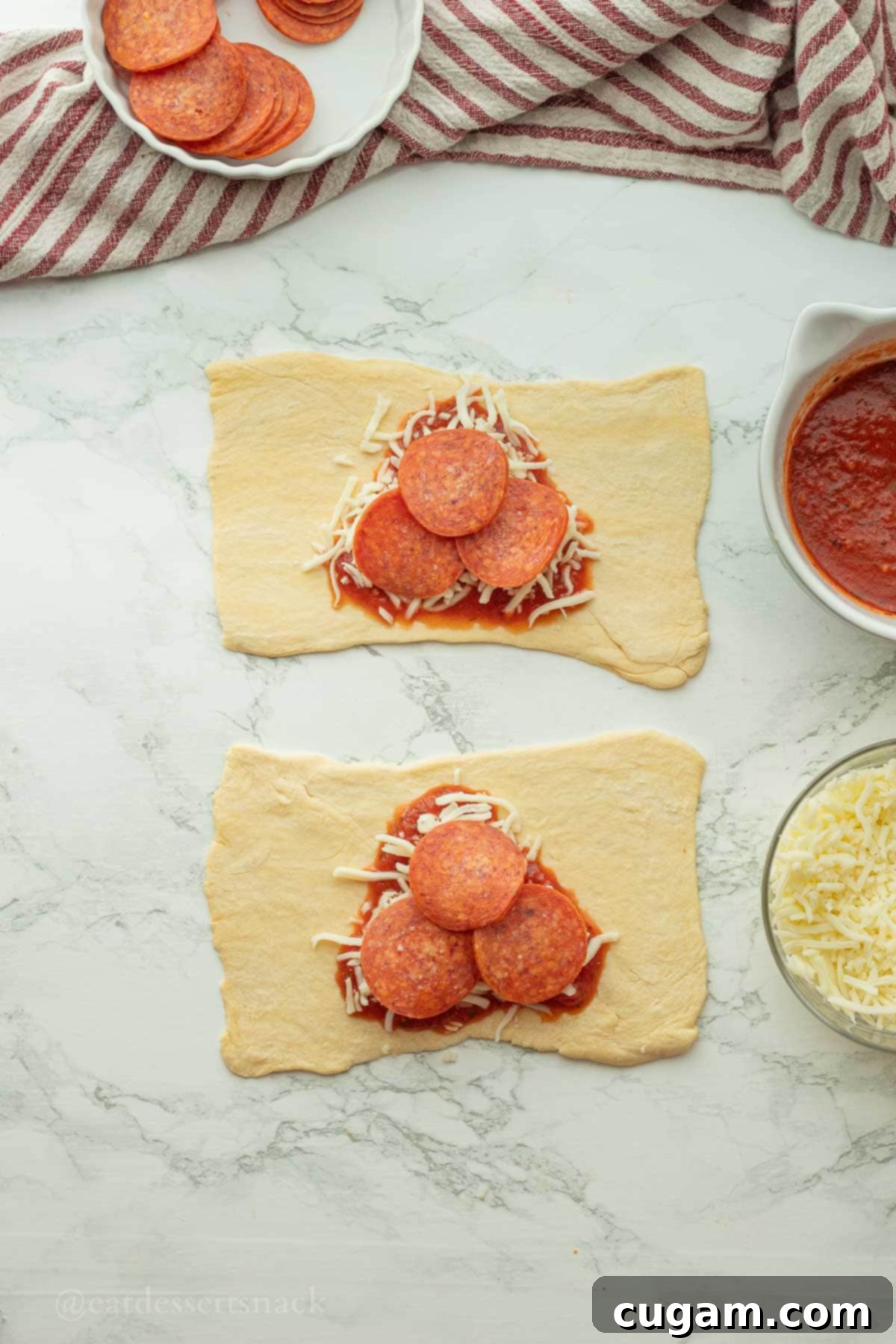 Halloween Witchy Crescent Treats 7 Pepperoni with pizza sauce and cheese on raw crescent dough.