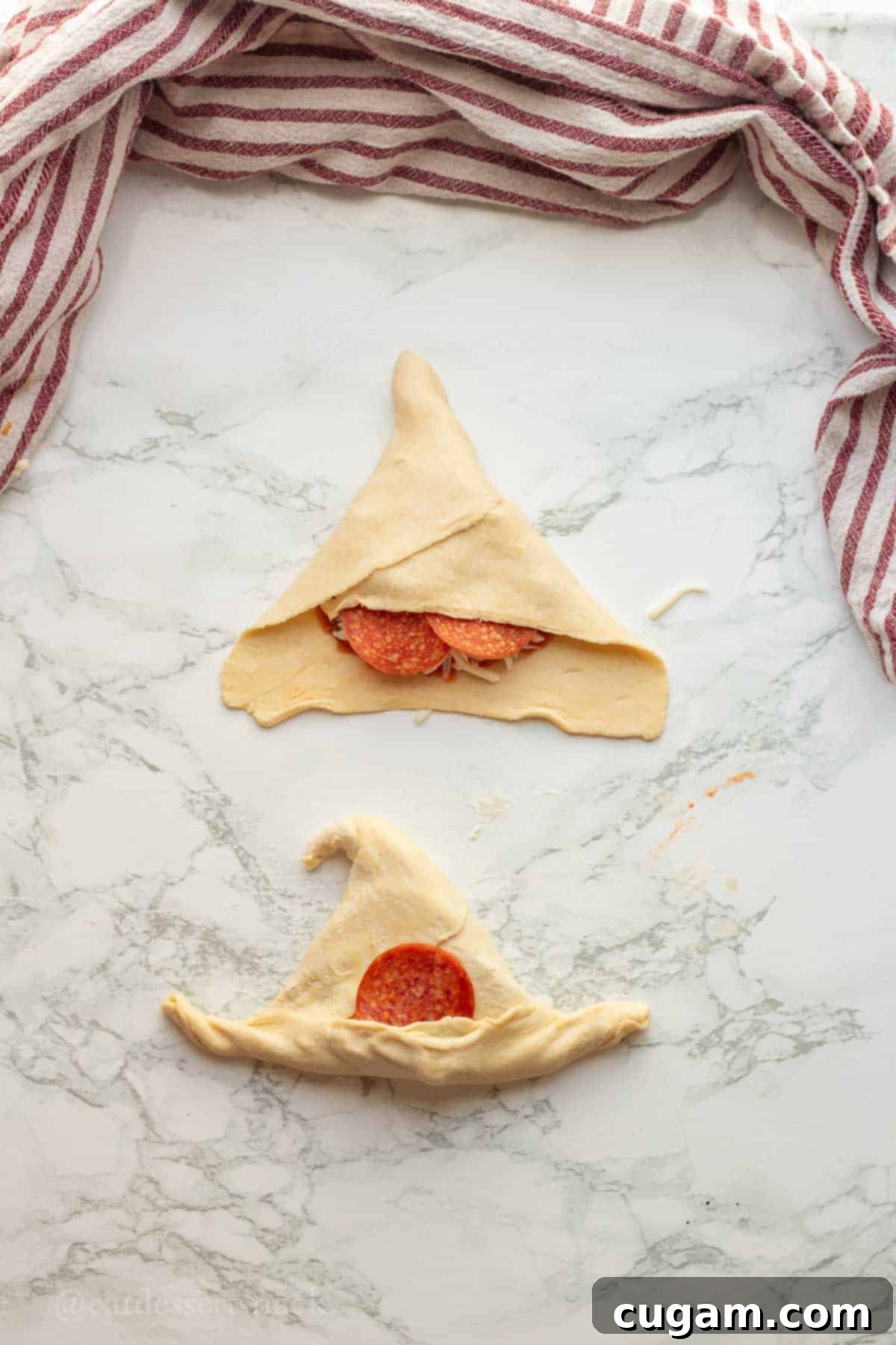 Halloween Witchy Crescent Treats 9 Folding left corner down of raw dough.