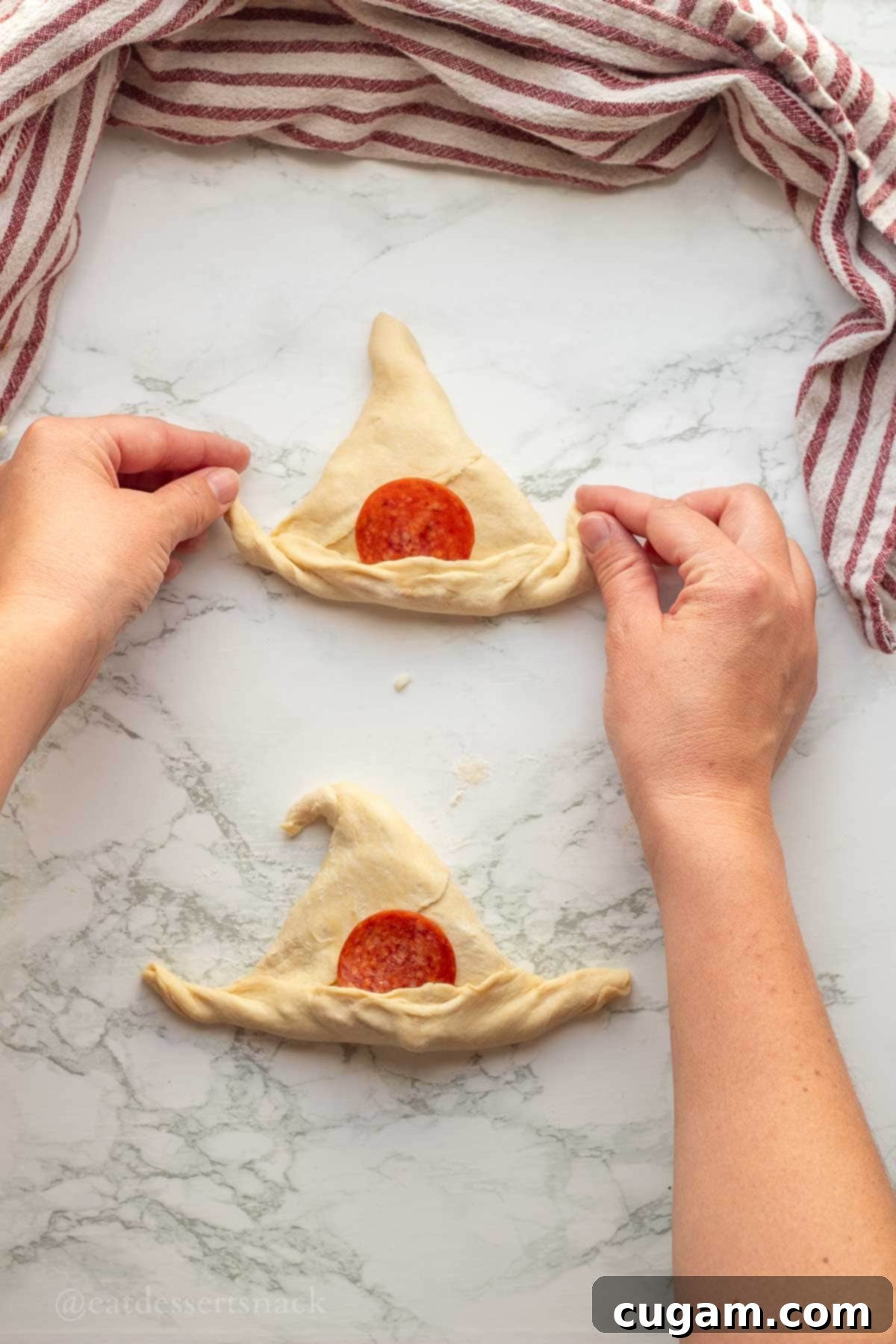 Halloween Witchy Crescent Treats 10 Curling edges of raw crescent dough upwards.