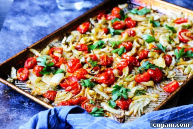 Roasted fennel with tomatoes on a cookie sheet