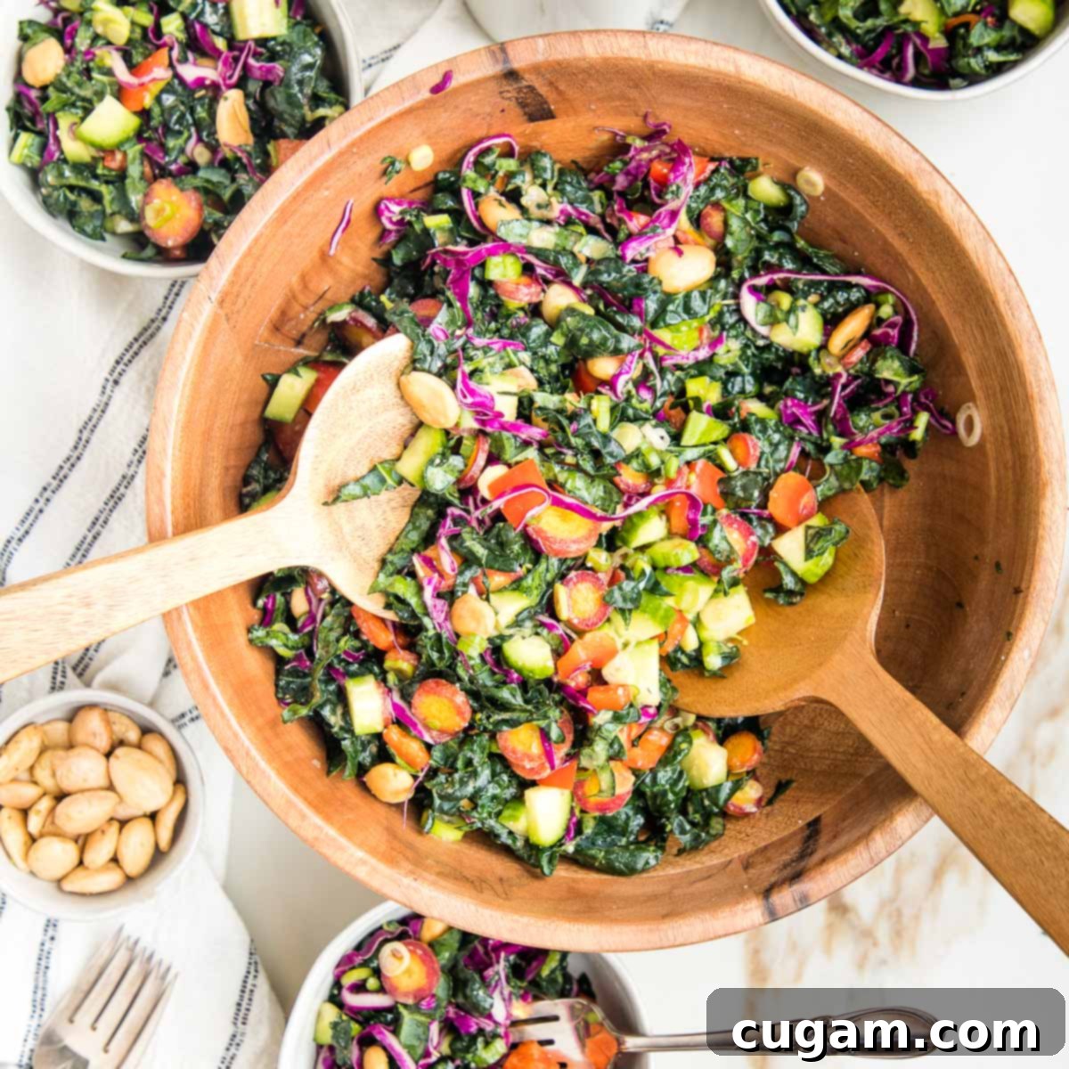 A vibrant and colorful chopped Tuscan kale salad beautifully presented in a rustic wooden bowl.