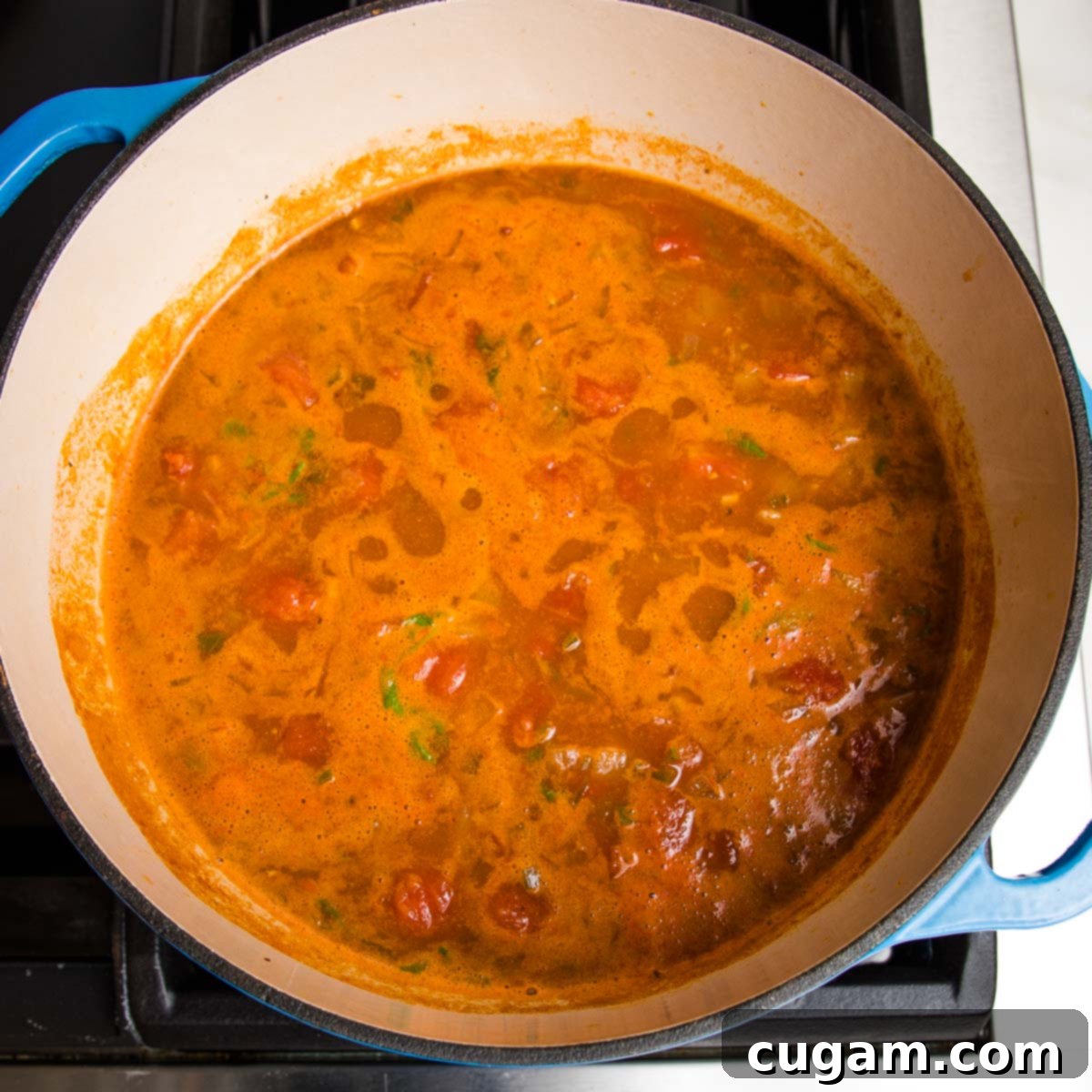 taco soup simmering on the stove in a dutch oven.