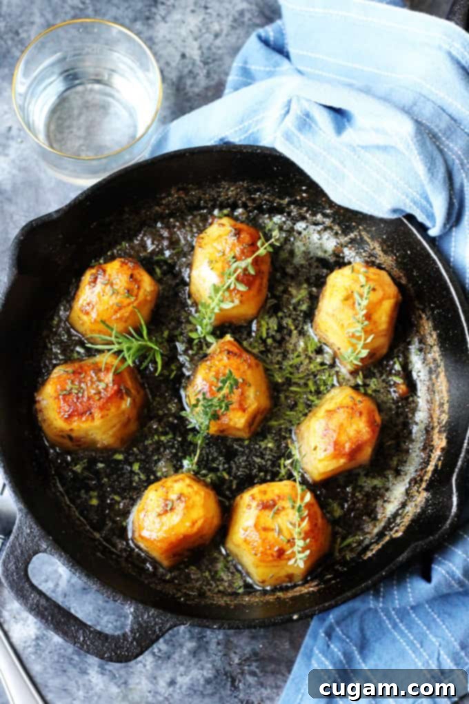 Fondant Potatoes in cast iron skillet with herbs