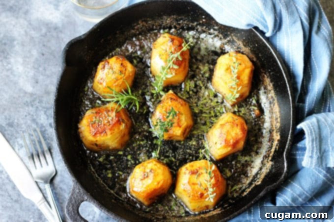 Horizontal Photo of Fondant potatoes in a cast iron sklllet