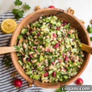 wooden bowl filled with bean salad including kidney beans, white beans, lots of green and radishes.