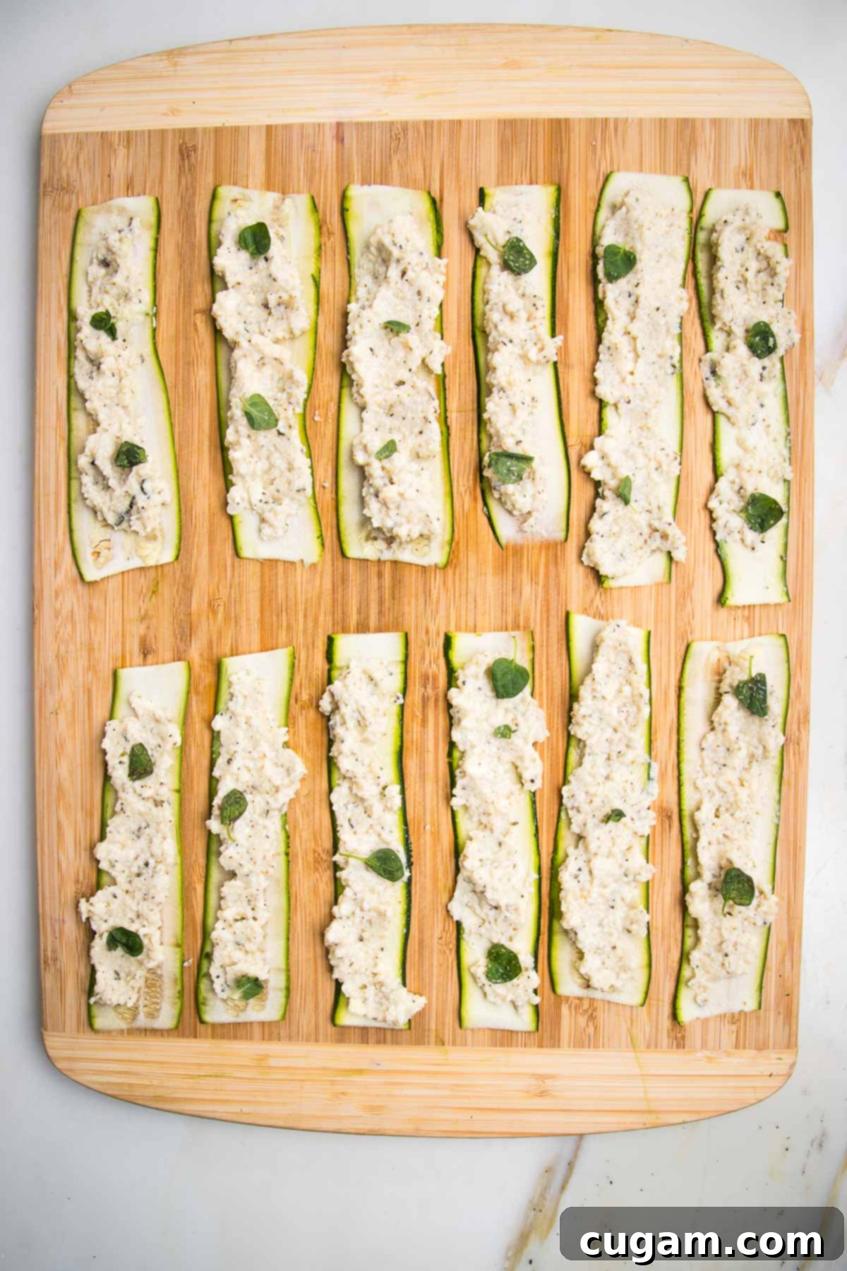 Zucchini strips, spread with vegan ricotta and sprinkled with fresh oregano