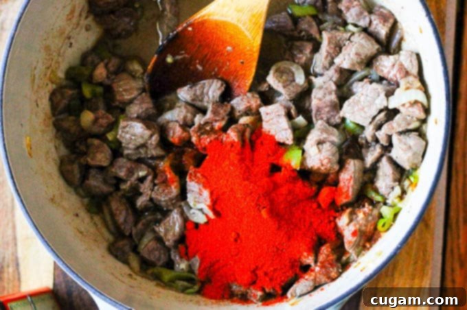 Adding Hungarian paprika to beef and onions