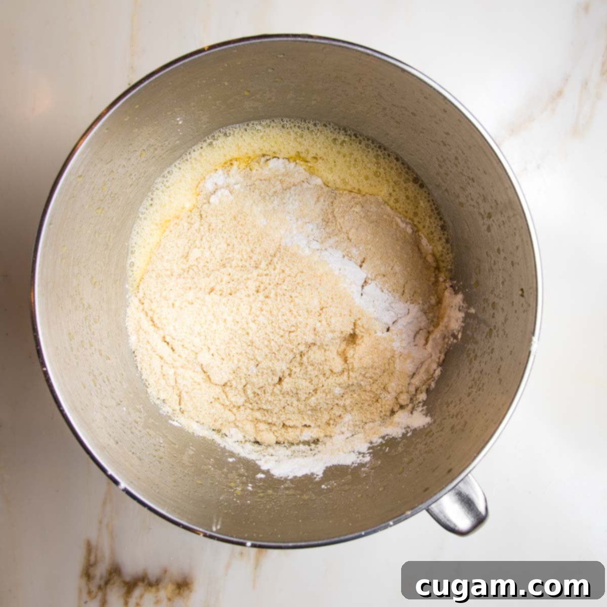 Dry ingredients mixed into wet ingredients, creating cake batter.