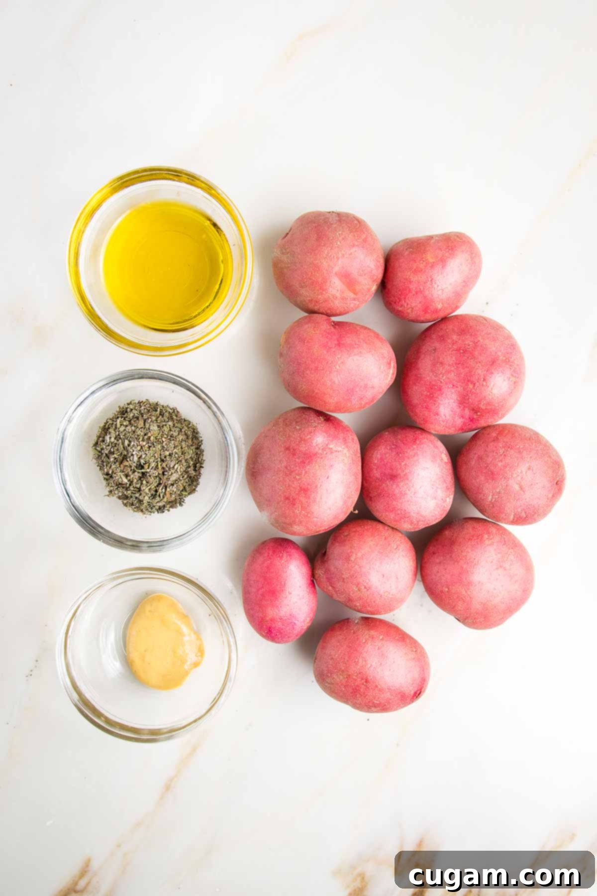 Small red potatoes, with three tiny glass bowls with olive oil, herbs de Provence and dijon mustard.