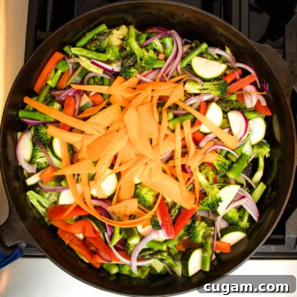 Carrot ribbons added to the vegetable mixture.