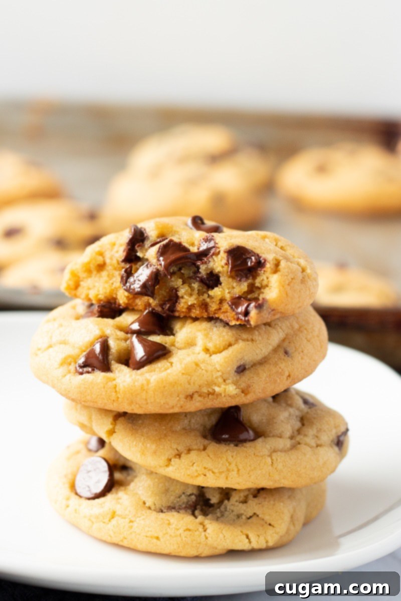 A perfectly baked stack of four chewy chocolate chip pudding cookies, ready to be enjoyed.
