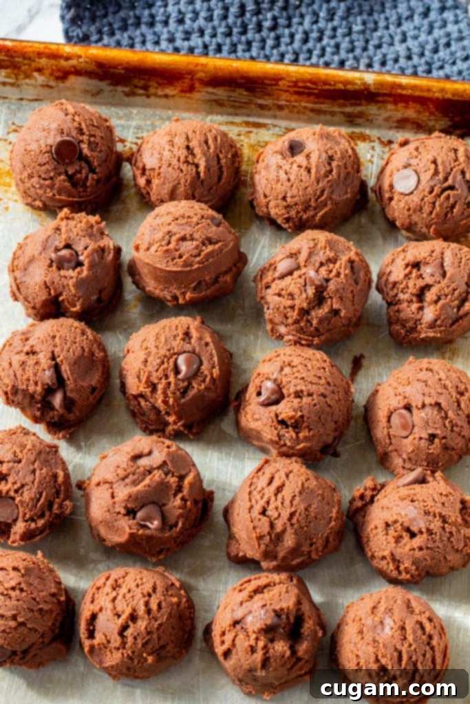 Raw Chocolate pudding cookie dough balls on a pan. 