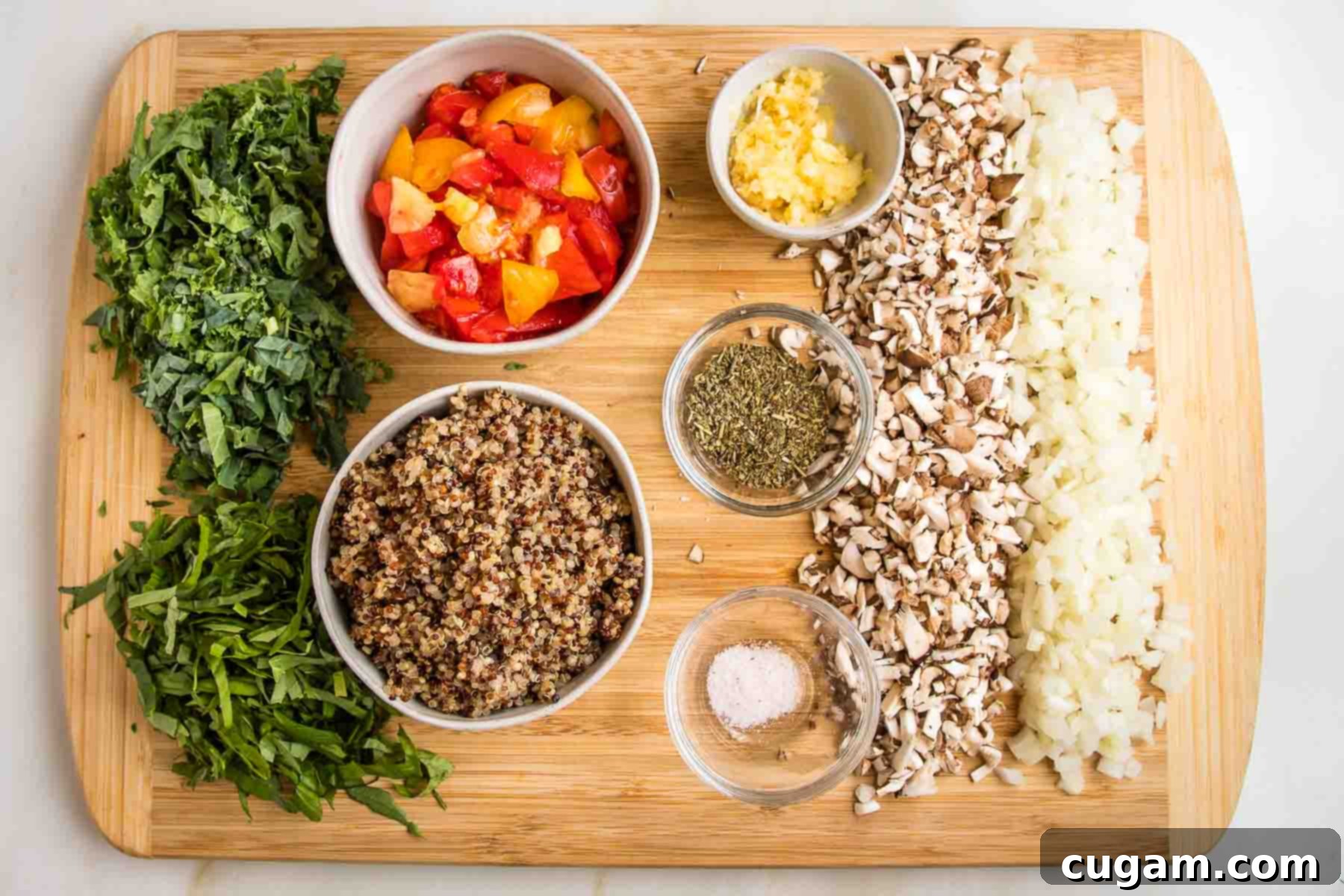 Chopped kale, basil, mushrooms and onions. Bowls filled with quinoa, chopped tomato pulp, grated garlic, salt, italian seasoning, nutritional yeast. 