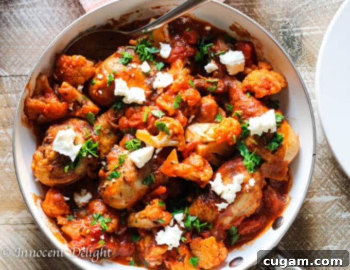 Plated Greek Chicken with Tomatoes, Cauliflower and Feta