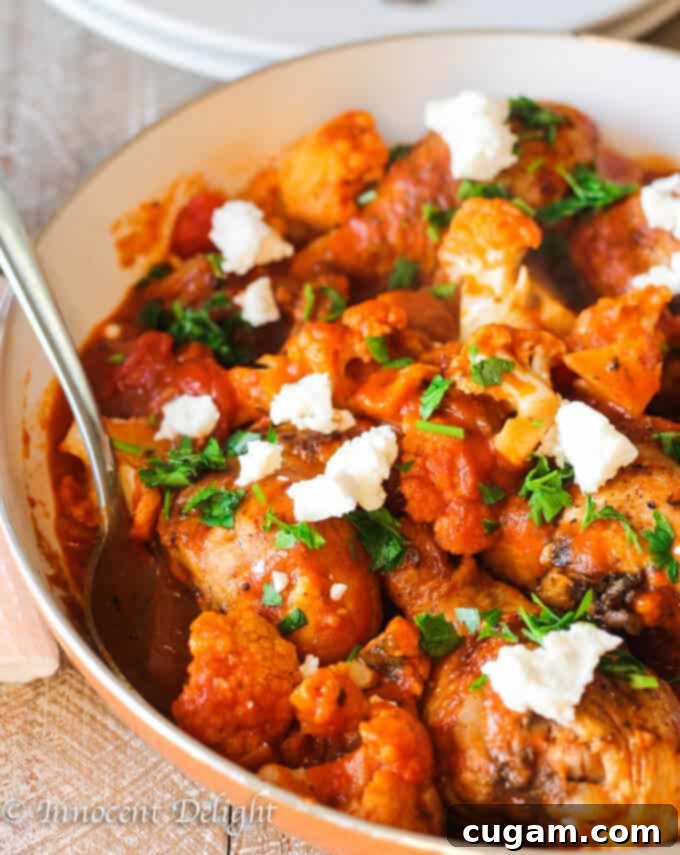Close-up of Greek Chicken with Tomatoes, Cauliflower and Feta in a skillet