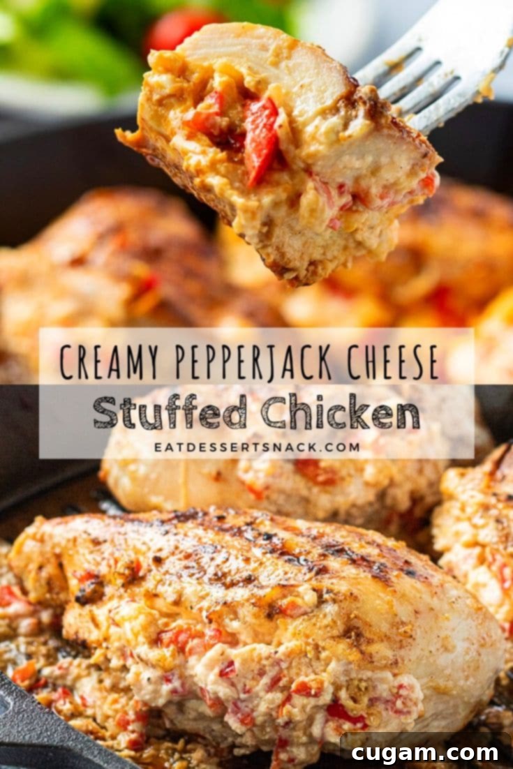 Fork with baked creamy pepperjack stuffed chicken, showcasing the melted cheese filling