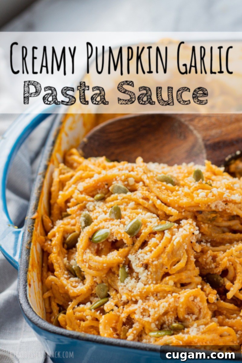 Cooked creamy pumpkin pasta in a blue pan, garnished with herbs.