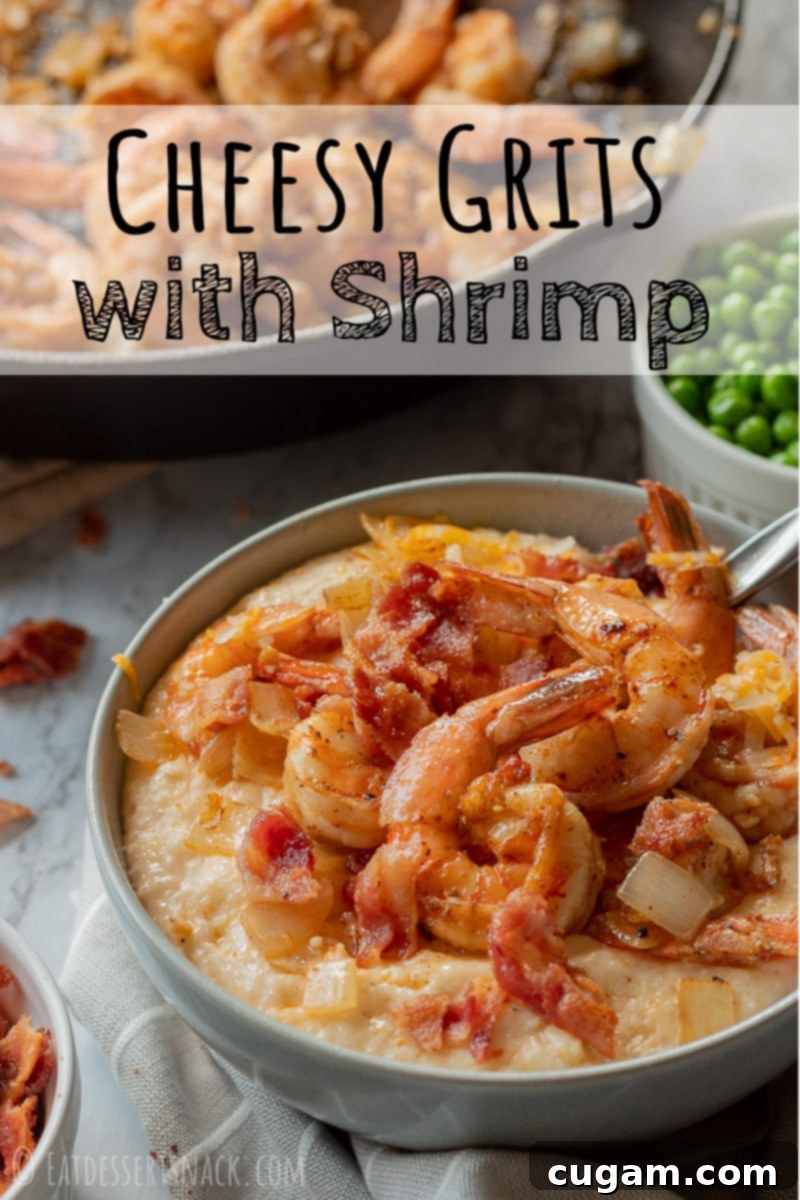 Cooked Cheesy Shrimp and Grits in a gray bowl, generously topped with crispy bacon and fresh herbs.