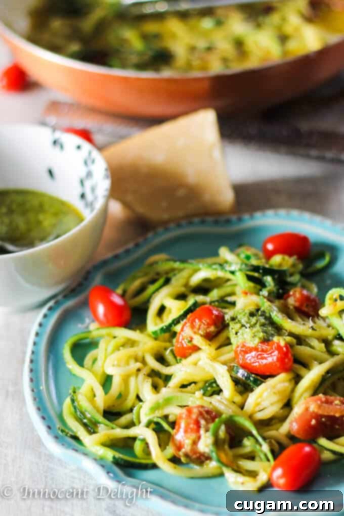 Close-up of Pesto Zucchini Noodles with cherry tomatoes, showcasing the fresh ingredients and appetizing texture.